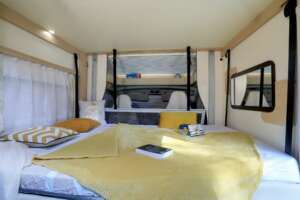 Pavilion bed in a profiled motorhome